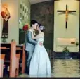  ??  ?? For wet or for dry? Mr and Mrs Campo share a more passionate kiss in the flooded church where they were wed