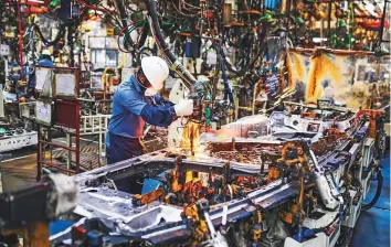  ?? Bloomberg ?? A worker at the welding line on the Innova Crysta compact multi-purpose vehicle production line at the Toyota Kirloskar Motor Ltd. plant in Bidadi, Karnataka, India.