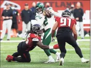  ?? Ryan Pierse / TNS ?? Zach Wilson of the New York Jets is sacked by Steven Means (55) of the Atlanta Falcons on Oct. 10.