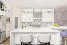  ?? Jeanette Bergen Photograph­y ?? The new kitchen took about 3 feet from the dining room and features durable quartz counters, a bigger island and beautiful plum accents in the backsplash tile.