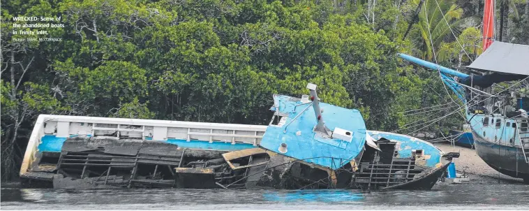  ??  ?? WRECKED: Some of the abandoned boats in Trinity Inlet. Picture: MARC McCORMACK