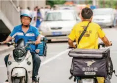  ??  ?? July 21, 2017, Beijing: Near the lunch hour, food delivery drivers are seen everywhere in Zhongguanc­un. According to a recent report released by BigdataRes­earch, in the first quarter of 2017, Ele.me continued to lead the industry with a market share of...