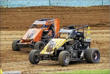  ?? SUBMITTED PHOTO - CARL HESS ?? Side-by-side mud-slinging at Action Track USA with Josh Heckman (12) on the inside line and Sam Kravitsky (14) outside last Wednesday.