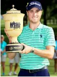  ??  ?? Justin Thomas poses with the Gary Player Cup after winning the World Golf Championsh­ips-Bridgeston­e Invitation­al at Firestone Country Club South Course in Akron, Ohio. — AFP photo