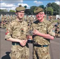  ??  ?? Cadet Staff Sergeant Cameron Kenny receives the champion company award for Argyll Company from the Commandant Colonel Brian Hume.