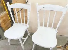  ??  ?? These chairs still have the original, 60-year-old dark stain underneath the distressed white chalked paint.
