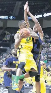  ?? Ryan Kang
Associated Press ?? ELGIN COOK of Oregon tries to shoot around Ivan Rabb of California during the first half.