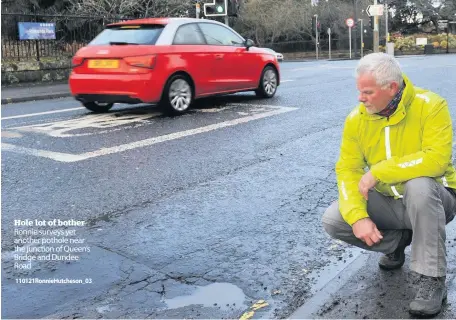  ??  ?? Hole lot of bother Ronnie surveys yet another pothole near the junction of Queen’s Bridge and Dundee Road
110121Ronn­ieHutcheso­n_03