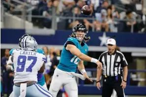  ?? The Associated Press ?? ■ Dallas Cowboys defensive end Ron’Dell Carter (97) pressures as Jacksonvil­le Jaguars quarterbac­k Trevor Lawrence (16) throws a pass in the first half of an Aug. 29 preseason game in Arlington, Texas.