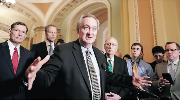  ?? J. SCOTT APPLEWHITE / THE ASSOCIATED PRESS ?? Sen. Mike Crapo, R-Idaho, chairman of the Senate Banking Committee, joined by, from left, Sen. John Barrasso, R-Wyo., Sen. John Thune, R-S.D., and Senate Majority Leader Mitch McConnell, R-Ky., right, talks as the Senate moves closer to rolling back...