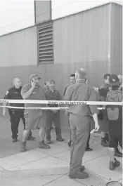  ?? ERIC RISBERG, AP ?? UPS workers gather outside after a reported shooting at a warehouse and customer service center in San Francisco on Wednesday. Police confirmed a shooting at the facility in the Potrero Hill neighborho­od.