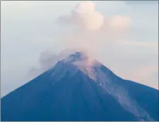  ?? AP PHOTO ?? The Volcan de Fuego, or Volcano of Fire, blows out a cloud of ash, as seen from Escuintla, Guatemala yesterday.