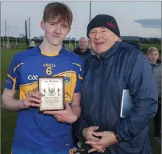  ??  ?? Tomacork’s James McGing receives his Wicklow People Man of the Match award from Liam O’Loughlin.