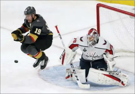  ?? ROSS D. FRANKLIN — THE ASSOCIATED PRESS ?? Vegas Golden Knights right wing Reilly Smith, left, jumps out of the way of a shot that was stopped by Washington Capitals goaltender Braden Holtby during the third period in Game 2of the NHL hockey Stanley Cup Finals on Wednesday in Las Vegas.