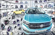  ??  ?? A Volkswagen T-Roc (left), and a Volkswagen T-Cross are presented at the storage facility auto tower of German carmaker Volkswagen in Wolfsburg on Dec 4. (AFP)