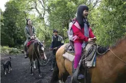  ??  ?? Tourists ride horses to the summit of the Pacaya volcano in San Francisco de Sales, Guatemala.