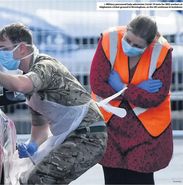  ?? Jacob King ?? > Military personnel help administer Covid-19 tests for NHS workers at Edgbaston cricket ground in Birmingham, as the UK continues in lockdown