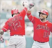  ?? Ben Margot Associated Press ?? LUIS VALBUENA celebrates with teammate Martin Maldonado after hitting a three-run home run.