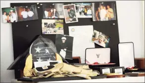  ?? Hearst Connecticu­t Media file photo ?? Awards, medals, photos and other memorabili­a sit on a table at Pat and Michael Parry’s home. The Parrys are the parents of Navy SEAL Brian Bill.