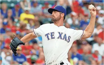  ?? RAYMOND CARLIN III, USA TODAY SPORTS ?? Thanks to a no-trade clause, Cole Hamels is pitching for the first-place Rangers, not the Astros.