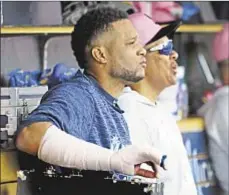  ?? GETTY ?? Robinson Cano sits in dugout with right arm in cast after fracturing hand during Mariners’ loss Sunday.