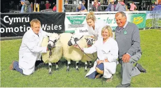  ??  ?? > The Supreme Interbreed Sheep champions, a Welsh Hill Speckled Face sheep, yearling ram and four-year-old ewe lamb, with Edryd, Caren and Gwenan Jones and judge David Jones