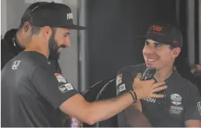  ?? CP PHOTO BY ANDREW LAHODYNSKY­J ?? Canadian racing drivers James Hinchcliff­e and Robert Wickens share a laugh at the Honda Indy in Toronto, on Thursday.