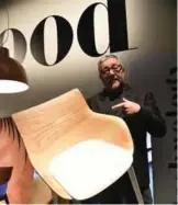  ??  ?? French designer Philippe Starck shows a chair from his collection made from wood at the Kartell stand.