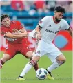  ?? ICON SPORTSWIRE GETTY IMAGES ?? Chicago Fire midfielder Brandt Bronico grabs the shirt of TFC midfielder Jonathan Osorio as they battle for the ball in Bridgeview, Ill., on Saturday. TFC halted a six-game MLS slump.