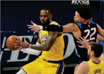  ?? AP PHOTO BY SUE OGROCKI ?? Los Angeles Lakers forward Lebron James, left, moves around Oklahoma City Thunder forward Isaiah Roby (22) during the first half of an NBA basketball game Wednesday, Jan. 13, in Oklahoma City.