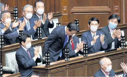  ?? BLOOMBERG ?? Fumio Kishida bows as he receives a round of applause after being elected as prime minister during an extraordin­ary session at the lower house of parliament in Tokyo, Japan, yesterday.