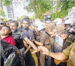  ?? ?? University students and police clash during a demonstrat­ion demanding the resignatio­n of Sri Lanka’s President Gotabaya Rajapaksa over the country’s crippling economic crisis, in Colombo on Thursday.