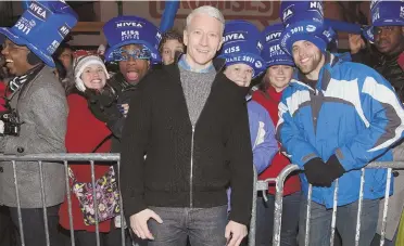  ?? GETTY IMAGES PHOTO ABOVE, AP PHOTO TOP RIGHT ?? PARTY TIME: Anderson Cooper, above, returns to Times Square to host CNN’s New Year’s Eve show, this time with Andy Cohen, top right, as his co-host.