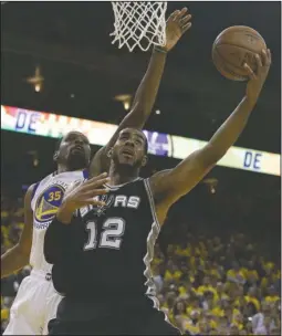  ?? The Associated Press ?? GOING FOR TWO: San Antonio Spurs forward LaMarcus Aldridge (12) shoots against Golden State Warriors forward Kevin Durant during the second half of Game 1 of the NBA basketball Western Conference finals in Oakland, Calif., Sunday. The Warriors won...