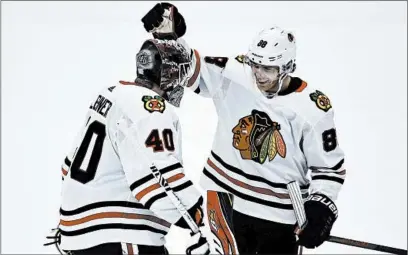  ?? KELVIN KUO/AP ?? Goaltender Robin Lehner, left, and right wing Patrick Kane celebrate a win over the Ducks last month. The two have carried the Hawks.