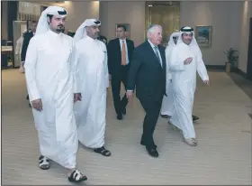  ?? AP/State Department/ALEXANDER W. RIEDEL ?? U.S. Secretary of State Rex Tillerson walks Thursday with Qatari Minister of Foreign Affairs Sheikh Mohammed bin Abdulrahma­n Al Thani (right) and others after arriving in Doha, Qatar.