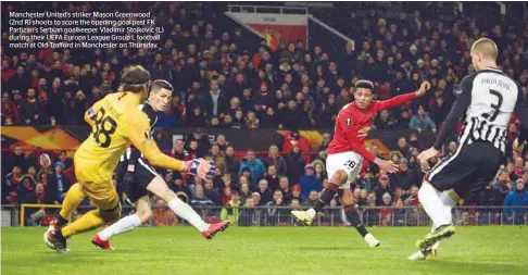  ??  ?? Manchester United’s striker Mason Greenwood (2nd R) shoots to score the opening goal past FK Partizan’s Serbian goalkeeper Vladimir Stojkovic (L) during their UEFA Europa League Group L football match at Old Trafford in Manchester on Thursday.