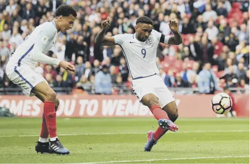  ??  ?? 0 Jermain Defoe scores England’s opening goal in the 2-0 victory over Lithuania at Wembley on Sunday.