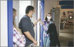  ?? (NWA Democrat-Gazette/Charlie Kaijo) ?? Boys & Girls Club Youth of the Year honorees Omar Contreras fist bumps Samantha M. last week at the Boys & Girls Club Teen Center in Rogers.