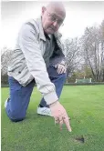  ??  ?? Angry Colin Logan, club’s vice president points out some of the damage to the green