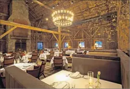  ?? Photograph­s by
Jon Whittle ?? THE BARN at Blackberry Farm, with its chandelier­s, elegant chairs and silver service, features fine dining that owner Sam Beall calls “foothills cuisine.”