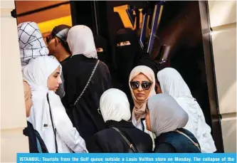  ?? — AFP ?? ISTANBUL: Tourists from the Gulf queue outside a Louis Vuitton store on Monday. The collapse of the Turkish lira has been an unexpected windfall for foreign tourists visiting the country at the peak of the summer season.