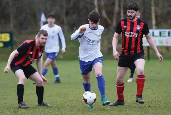  ??  ?? William Courtney, Killarney Athletic gets away from Tom Templeman and Chris Egan, Mastergeeh­a in the League at Woodlawn Killarney on Monday
Photo by Michelle Cooper Galvin