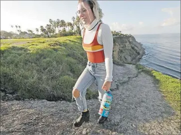  ?? Al Seib Los Angeles Times ?? WHITNEY TODOSIEV, a Palos Verdes High School junior, with a Hydro Flask she calls Barry. The bottle’s success, especially with young women, taps into anxiety about the environmen­t and interest in self-care.