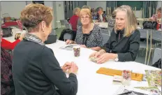  ??  ?? New Tusket WI president Karleen Gale watches new member Elinor Keter play cards with longtime member and former president and district director Roberta Journeay.