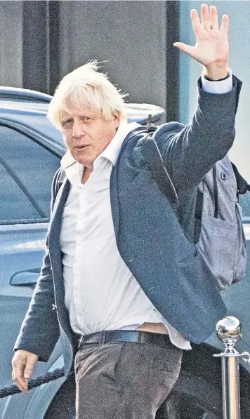  ?? ?? Boris Johnson arrives back in London from his Caribbean holiday yesterday. The former prime minister is expected to declare that he will run in the leadership race