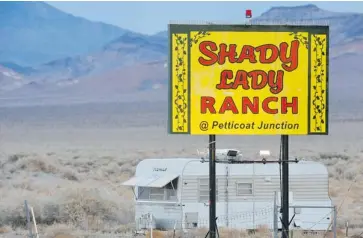  ?? ROBYN BECK/AFP/GETTY IMAGES ?? A sign leads the way to the Shady Lady Ranch brothel (not shown) in Nye County, Nev., about 241 kilometres north of Las Vega. Nevada’s legal bordellos are finding themselves in decline due to the impact of online services.