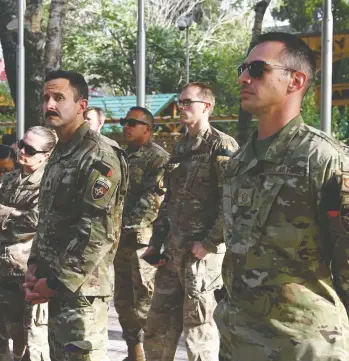  ?? WAKIL KOHSAR / AFP VIA GETTY IMAGES ?? U.S. military personnel stand during the official handover ceremony at Resolute Support headquarte­rs in the Green Zone in Kabul on Monday, part of the American withdrawal after 20 years in the war-torn country.