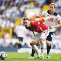 ??  ?? Phil Jones of Manchester United holds off his England team-mate Harry Kane as the striker looks to find a way past Manchester United’s centre-back