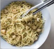  ?? DANIEL J. VAN ACKERE — AMERICA’S TEST KITCHEN VIA ASSOCIATED PRESS ?? This undated photo provided by America’s Test Kitchen in May 2018 shows spaghetti with lemon, basil and scallops in Brookline, Mass. This recipe appears in the cookbook “Cooking At Home With Bridget And Julia.”